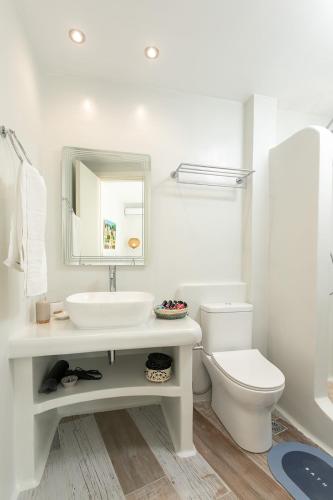 a white bathroom with a sink and a toilet at MNP Apartments in Engares