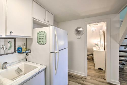 a white kitchen with a sink and a refrigerator at Romantic Pet-Friendly A-Frame on Lake Hamilton! in Hot Springs