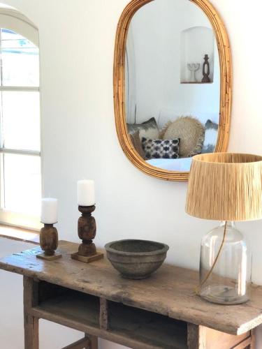 a table with a mirror and a lamp on it at Lodge - Le Clos Devançon in Gréoux-les-Bains