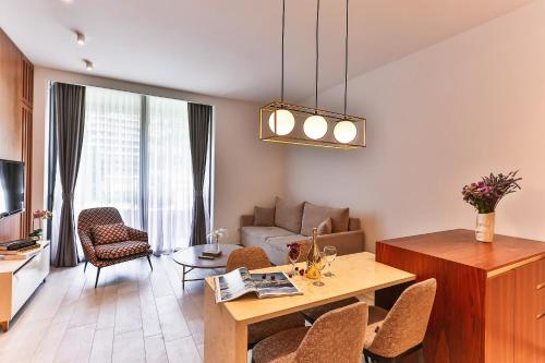 a living room with a table and a couch at Royal Montesun Apartments in Budva
