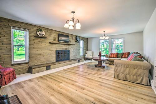 a living room with a couch and a fireplace at Roomy Montour Falls Retreat with Private Pool! in Montour Falls