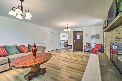 a living room with a couch and a table at Roomy Montour Falls Retreat with Private Pool! in Montour Falls