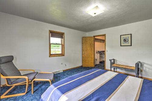 a bedroom with a bed and a chair in it at Stunning Wisconsin Retreat on Active Farm! in Spring Green