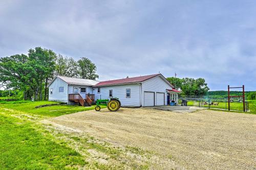 a green wagon parked in front of a house at Stunning Wisconsin Retreat on Active Farm! in Spring Green