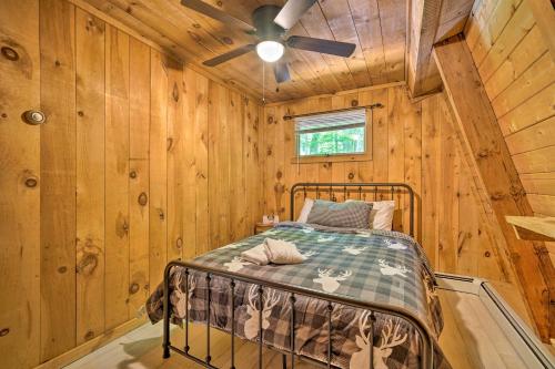 a bedroom with a bed in a wooden cabin at Wilmington Chalet with Hot Tub Less Than 8 Mi to Mount Snow! in Wilmington