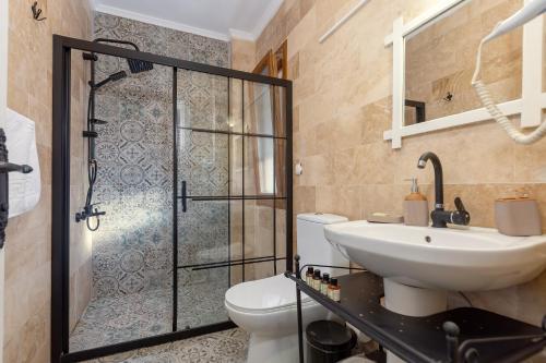 a bathroom with a toilet and a sink and a shower at Casa Di Datca in Datca