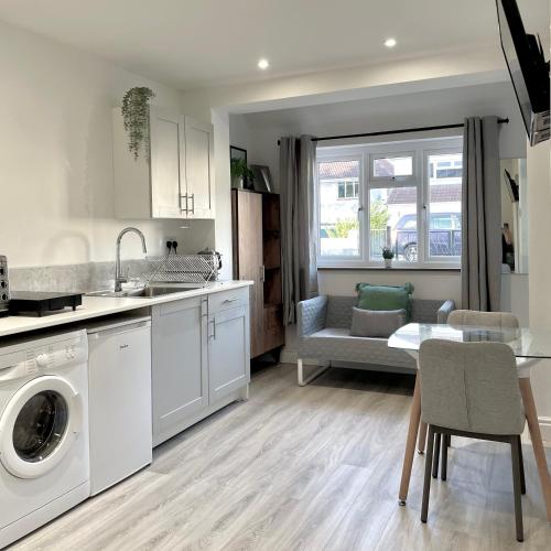 a kitchen with a washer and dryer and a table at Studio16 in Bristol
