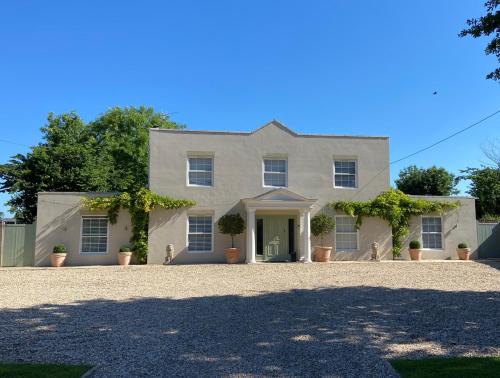 a large white house with a large driveway at Large Country House with Hot Tub, Pool Table, and Log Burner in Three Legged Cross