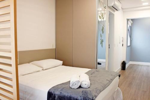 ein Schlafzimmer mit einem Bett mit zwei Handtüchern darauf in der Unterkunft Loft 811 Brooklin by OBA in São Paulo