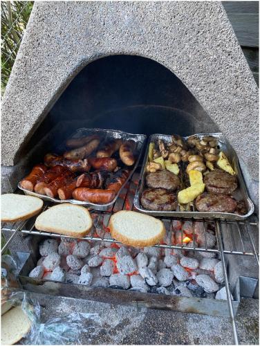 a grill with three trays of food on it at Apartamenty Villa Fiori - Wyspa Sobieszewska in Gdańsk