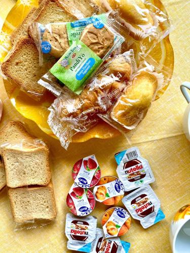 a table topped with bread and sandwiches and snacks at La Divina in Cosenza