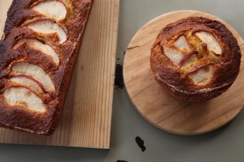 a loaf of bread on a wooden cutting board at Casa Carmina Hostel in Muros de Nalón