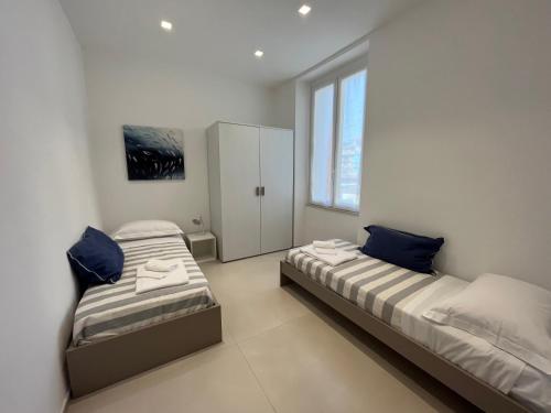 En eller flere senge i et værelse på Appartamento Aria di mare