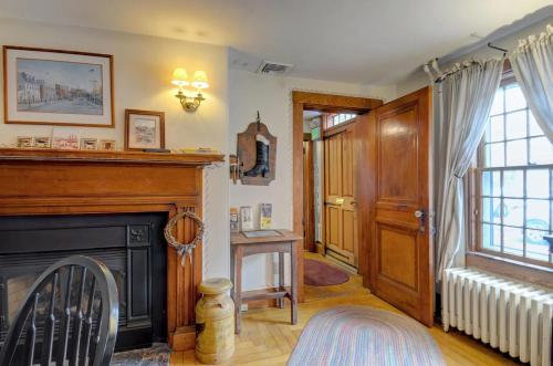 a living room with a fireplace and a chair at Melville House Newport in Newport