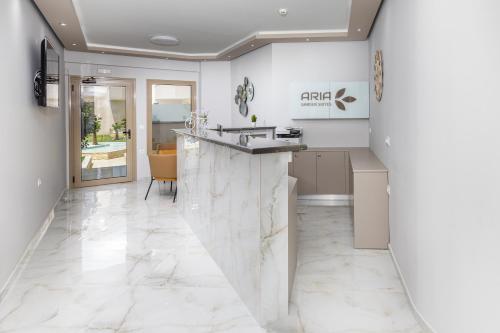 a lobby with a marble counter and a sink at Aria Garden Suites in Nikiti