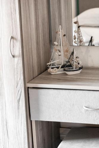 a wooden toy boat sitting on a shelf in a drawer at Vila Aleka in Nei Poroi