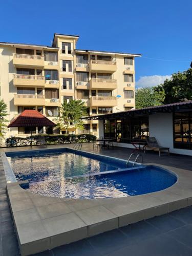 a swimming pool in front of a building at 3-bedroom apartment by Mas in Dar es Salaam