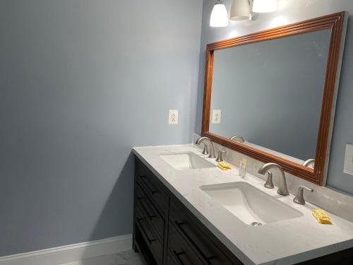 a bathroom with two sinks and a large mirror at Jersey Shore 1 & 3 Bedroom Premium Beach House in Seaside Heights