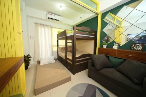 a living room with a bunk bed and a couch at A2J Luxury 1BR Tagaytay Suite Near Skyranch, Malls in Tagaytay