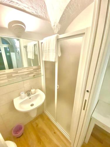 a bathroom with a shower and a sink at Biancomare - Casetta sul Mare in Polignano a Mare