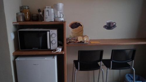 a desk with a microwave and a coffee maker at Good-Home Paseo de Gracia in Barcelona