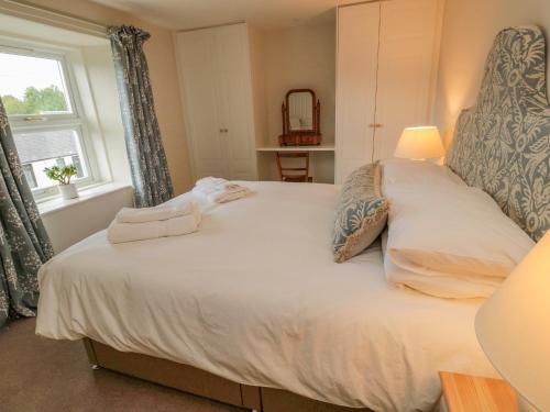 a bedroom with a large white bed with a window at 46 Castle Street in Berwick-Upon-Tweed