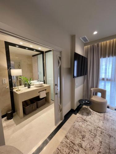 a bathroom with a sink and a television in a room at Maison Marineta in Denia