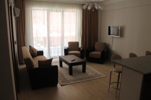 a living room with a couch and chairs and a table at Almasa Suite Aparts in Termal
