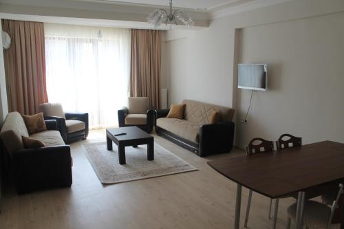 a living room with a couch and a table at Almasa Suite Aparts in Termal