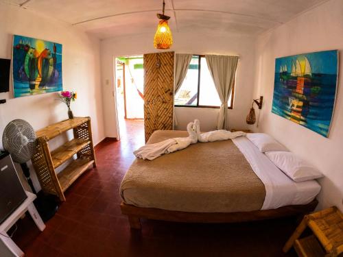 a bedroom with a large bed and a window at Hotel Punta Ballenas in Máncora