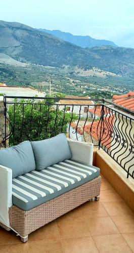 a couch sitting on a balcony with a view at Amphora Guesthouse in Himare