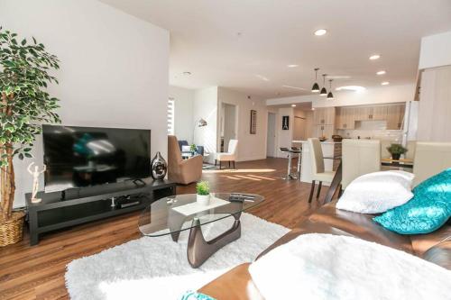a living room with a couch and a tv at Spacious 2bedroom FREE parking king bed close to DT in Edmonton