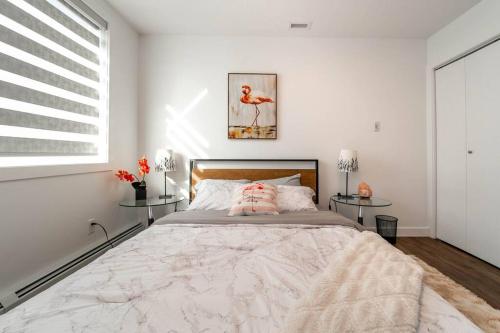 a bedroom with a large bed with two tables at Spacious 2bedroom FREE parking king bed close to DT in Edmonton