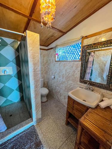 a bathroom with a sink and a shower and a toilet at Hotel Punta Ballenas in Máncora