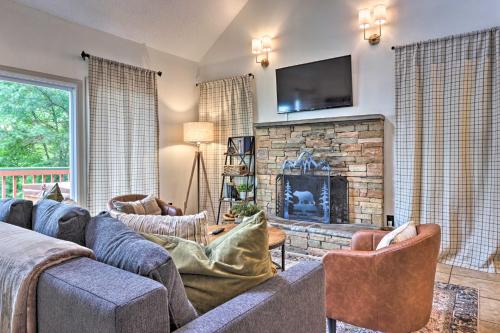 a living room with a couch and a fireplace at Gatlinburg Chalet Hot Tub, Sauna and Mountain View in Gatlinburg