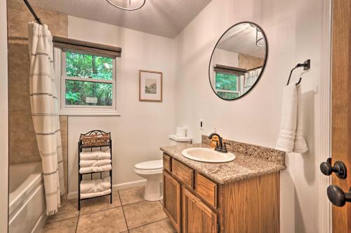 a bathroom with a sink and a toilet and a mirror at Gatlinburg Chalet Hot Tub, Sauna and Mountain View in Gatlinburg