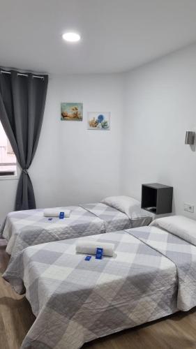 two beds sitting next to each other in a bedroom at Hostal Vara Madrid in Madrid