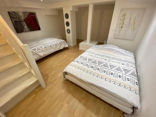 Ein Bett oder Betten in einem Zimmer der Unterkunft Duplex Cosy proche Paris(5mn)sans commission en +