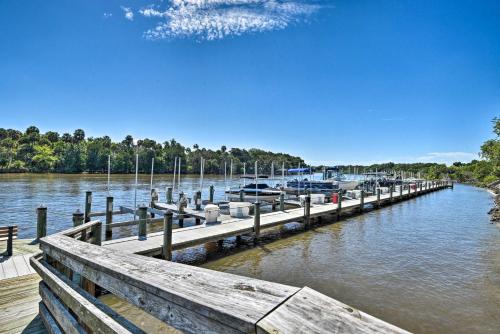 a dock with boats parked at a marina at Waterfront Palm Coast Condo with Boat Dock and Pool! in Palm Coast