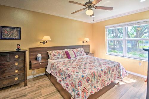 a bedroom with a bed and a dresser and a window at Waterfront Palm Coast Condo with Boat Dock and Pool! in Palm Coast