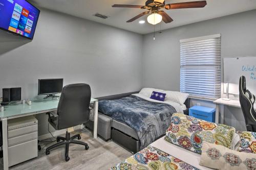 a bedroom with a bed and a desk with a computer at Waterfront Palm Coast Condo with Boat Dock and Pool! in Palm Coast
