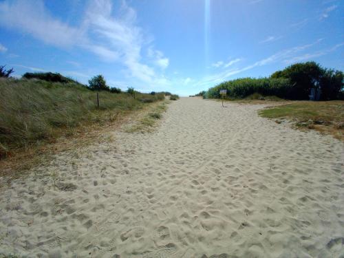 a dirt road leading down to the beach at La Ferme d' Emerentine in Bacilly