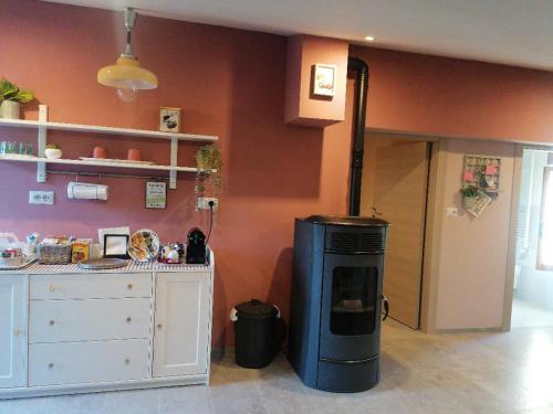 a kitchen with a stove in the corner of a room at La soffitta di Anita in Bedonia