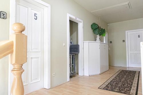 a living room with a white door and a rug at Exquisite Shared Villa - Your Private Room in this Beautiful Home in Vienna