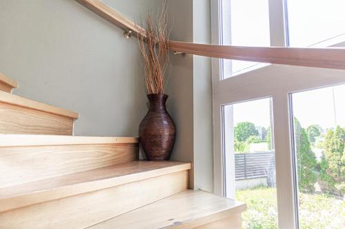 a vase sitting on a wooden shelf next to a window at Exquisite Shared Villa - Your Private Room in this Beautiful Home in Vienna