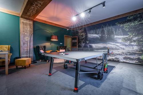 a ping pong table in a room with a painting at Rezydencja Markowy Dworek in Białka Tatrzanska