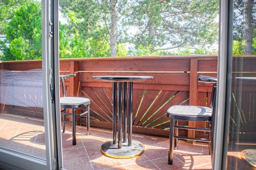 a balcony with a table and two stools at Exquisite Shared Villa - Your Private Room in this Beautiful Home in Vienna
