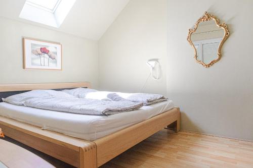 a bedroom with a bed with a mirror on the wall at Exquisite Shared Villa - Your Private Room in this Beautiful Home in Vienna