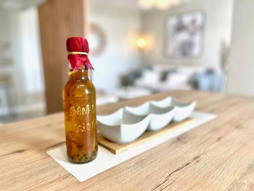 a bottle of sauce sitting on top of a table at Le "61" MARINA ROOFTOP 2CH 2SDB TERRASSE MARINA in Baimbridge