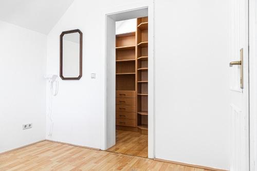 a room with a closet and a mirror at Exquisite Shared Villa - Your Private Room in this Beautiful Home in Vienna